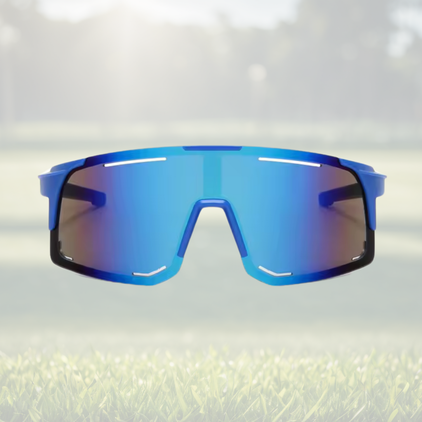 A pair of Sportiq Horizon Tidal performance sunglasses with blue reflective lenses and blue frame, UV400, polycarbonate frame with polycarbonate lens, displayed on a grass background.