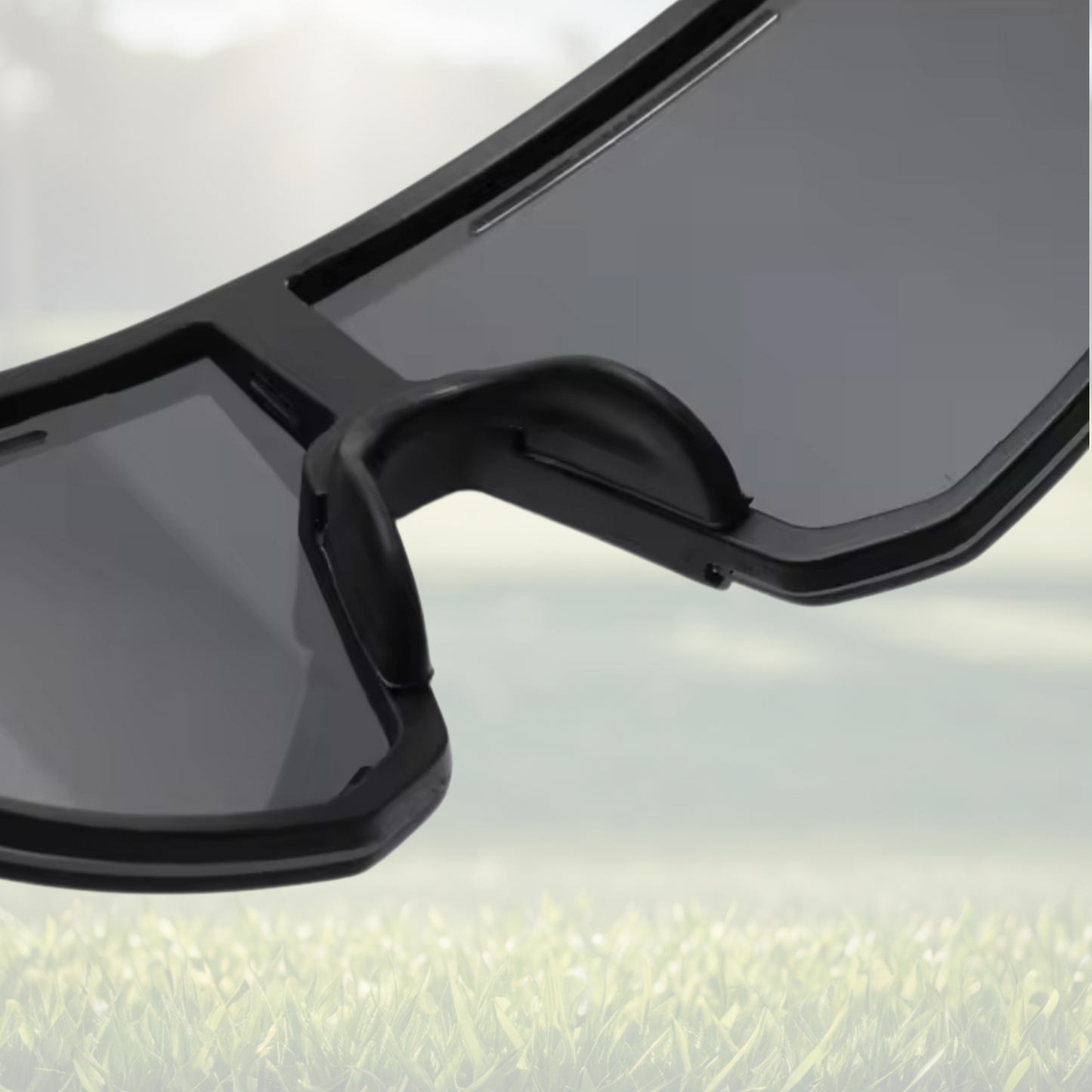 A pair of Sportiq Horizon Tidal performance sunglasses with blue reflective lenses and blue frame, UV400, polycarbonate frame with polycarbonate lens, displayed on a grass background.