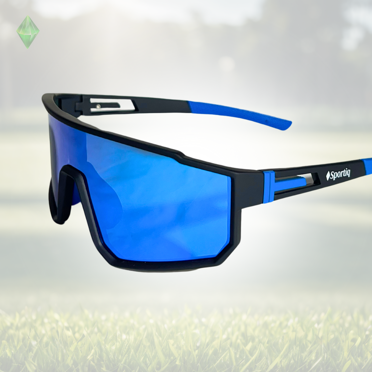 A pair of Sportiq VividShield sunglasses with blue reflective lenses and a black frame, polarized UV400, polycarbonate frame with TAC lens, displayed on a grass background.