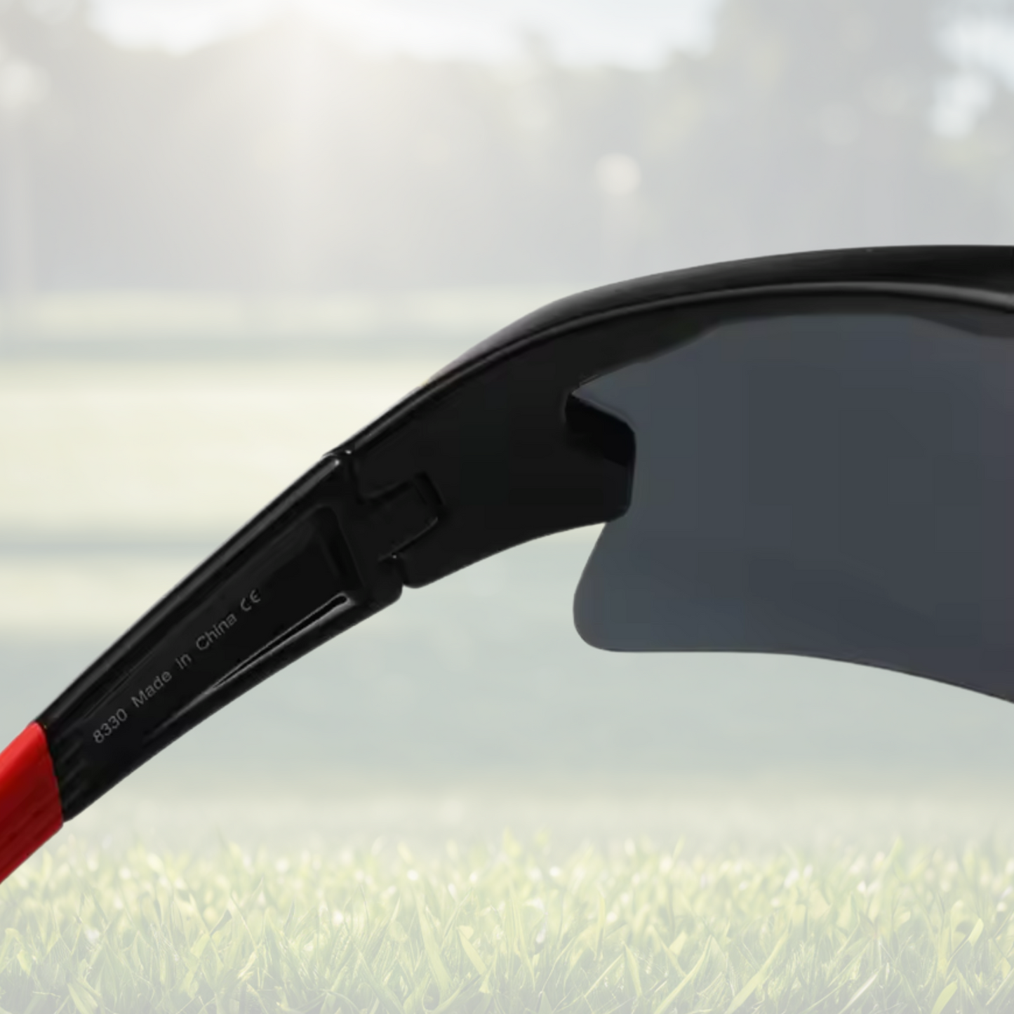 A pair of Sportiq Vector Eclipse performance sunglasses with reflective orange lenses and black frame, UV400, polycarbonate frame with polycarbonate lens, displayed on a grass background.