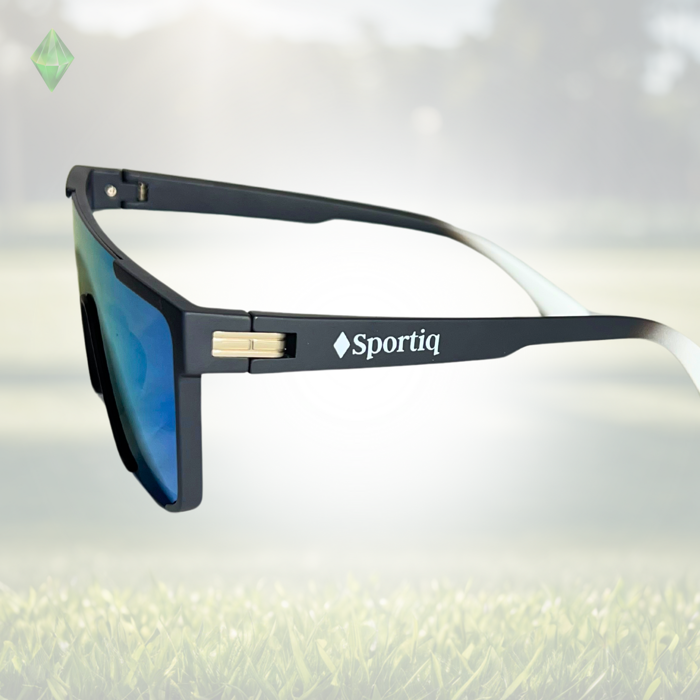 A pair of Sportiq Zen - Blue professional sport sunglasses with blue reflective lenses and black frame, polarized UV400, polycarbonate frame with TAC lens, displayed on a grass background.