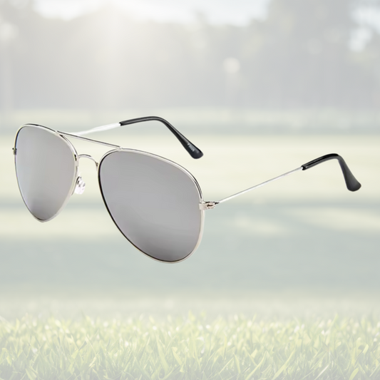 A pair of Sportiq Altitude Glacier professional performance sunglasses with reflective silver lenses and steel frame, UV400 with polycarbonate lens, displayed on a grass background.