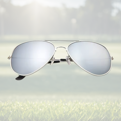 A pair of Sportiq Altitude Glacier professional performance sunglasses with reflective silver lenses and steel frame, UV400 with polycarbonate lens, displayed on a grass background.