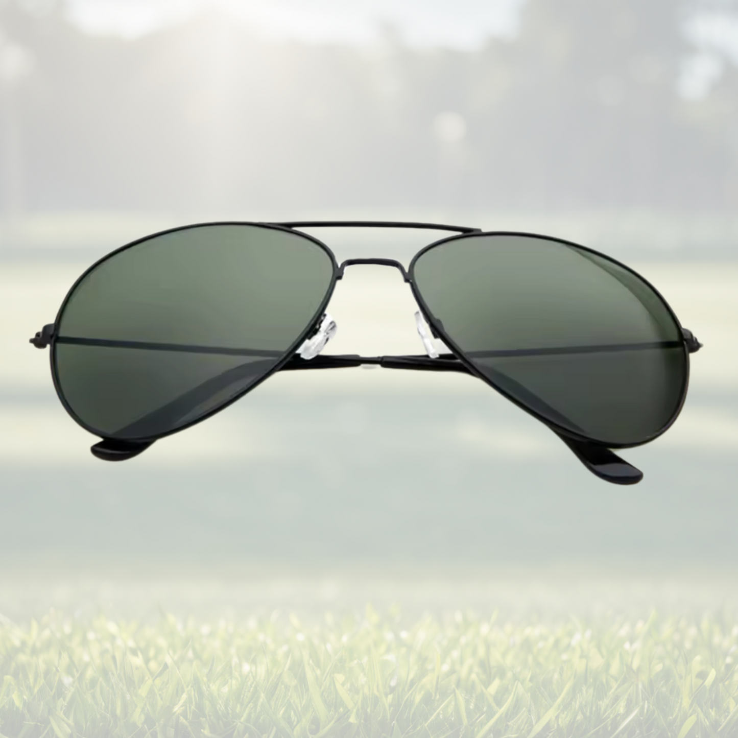 A pair of Sportiq Altitude Nightfall performance sunglasses with black lenses and steel frame, UV400, polycarbonate frame with polycarbonate lens, displayed on a grass background.