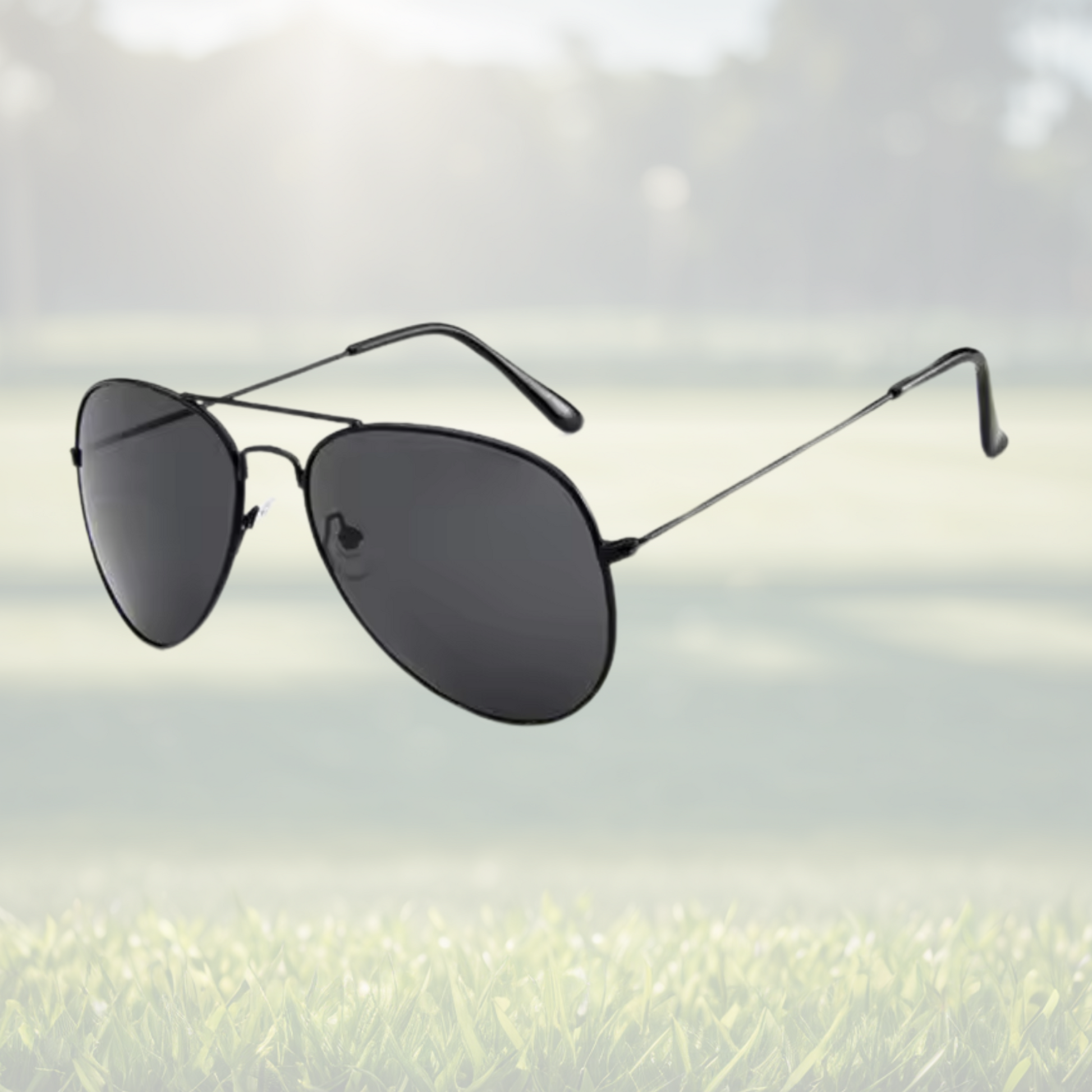 A pair of Sportiq Altitude Nightfall performance sunglasses with black lenses and steel frame, UV400, polycarbonate frame with polycarbonate lens, displayed on a grass background.