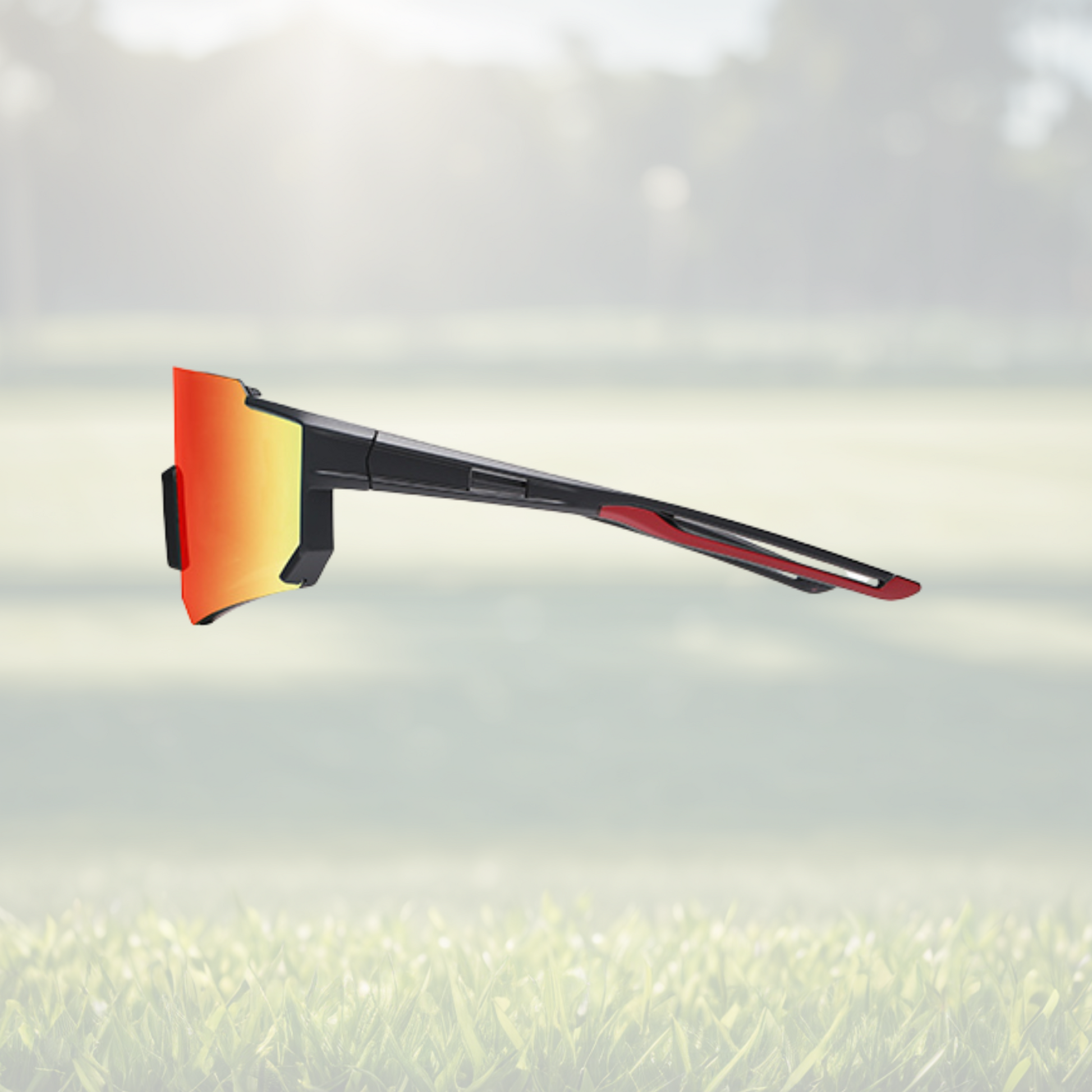 A pair of Sportiq Gamechanger Ember professional sport sunglasses with red reflective lenses and black frame, polarized UV400, polycarbonate frame with TAC lens, displayed on a grass background.