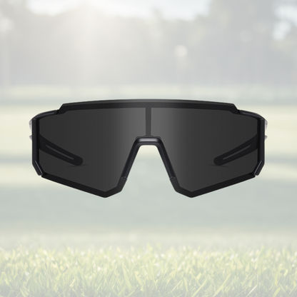A pair of Sportiq Gamechanger Stealth professional sport sunglasses with black lenses and black frame, polarized UV400, polycarbonate frame with TAC lens, displayed on a grass background.