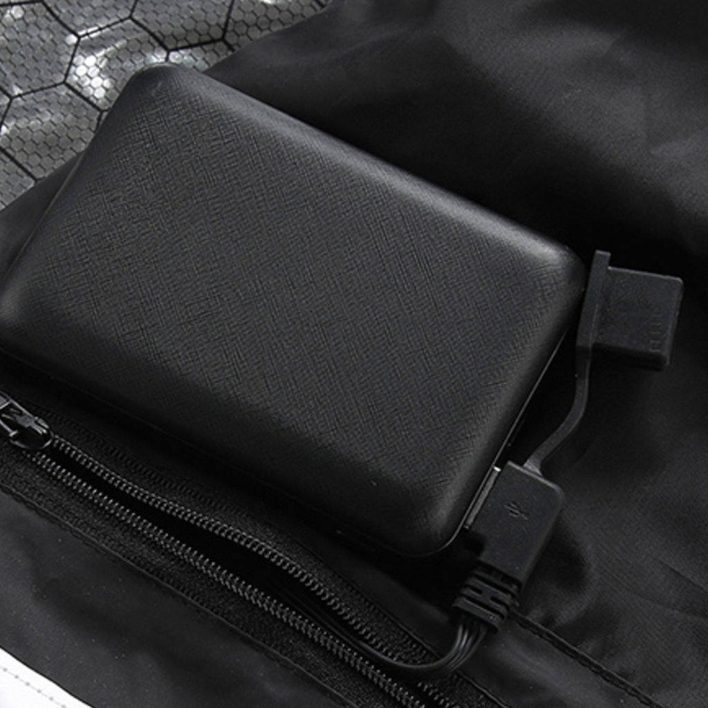 Showcase of battery connector for a Black Sportiq HeatCore Vest, puffer style and weatherproof, wind resistant with electric heated carbon fibre panels. 