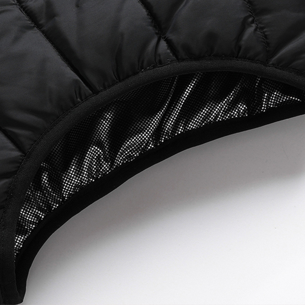Showcase of the neck and insulation for a Black Sportiq HeatCore Vest, puffer style and weatherproof, wind resistant with electric heated carbon fibre panels. 