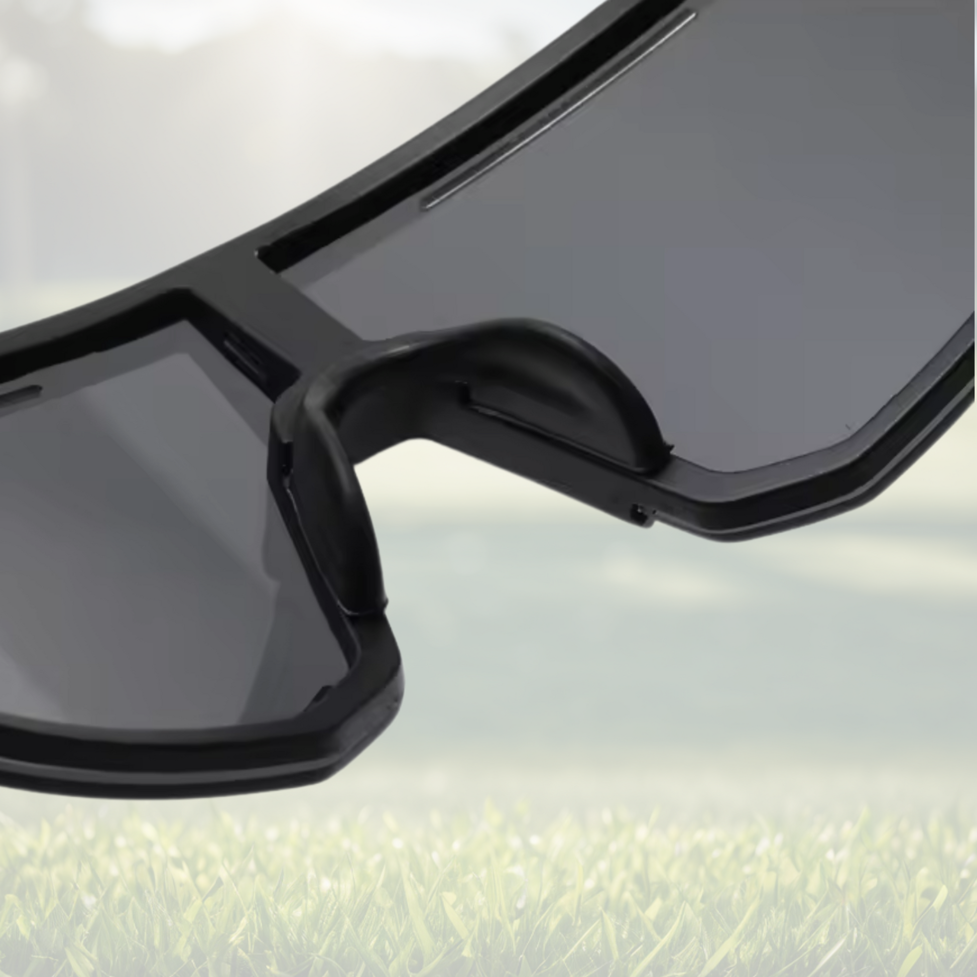 A pair of Sportiq Horizon Tidal performance sunglasses with blue reflective lenses and blue frame, UV400, polycarbonate frame with polycarbonate lens, displayed on a grass background.