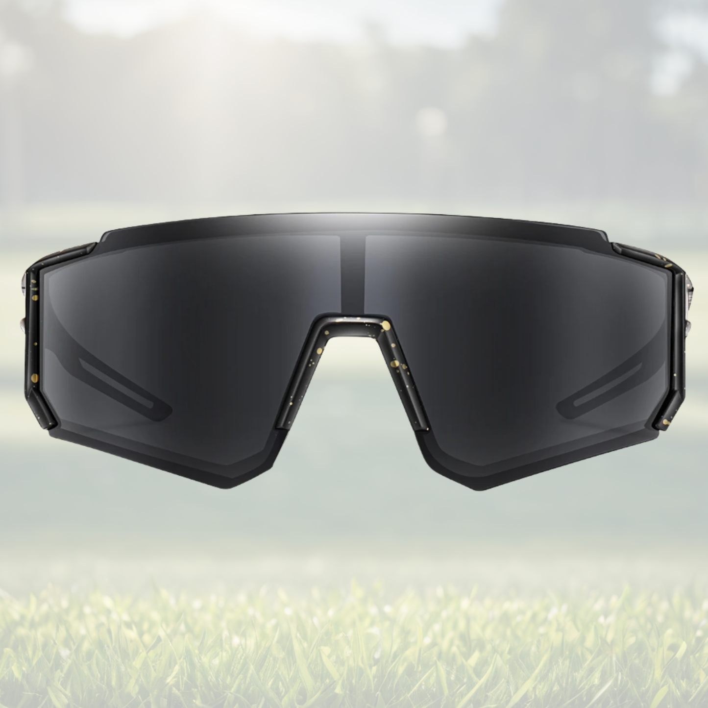 A pair of Sportiq JNR kids Jet Black sport sunglasses with black lenses and black frame, UV400, polycarbonate frame with polycarbonate lens, displayed on a grass background.