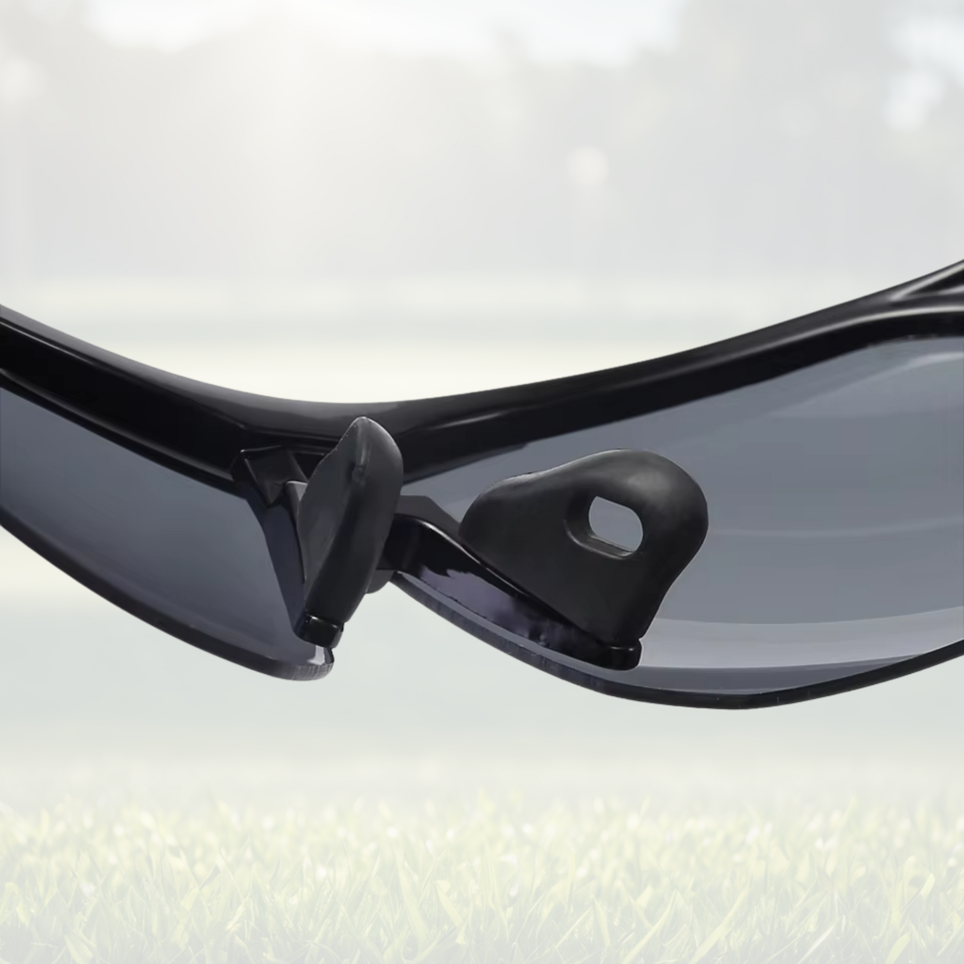 A pair of Sportiq OptiView - Crimson Glow professional sport sunglasses with red reflective lenses and black frame, polarized UV400, polycarbonate frame with TAC lens, displayed on a grass background.