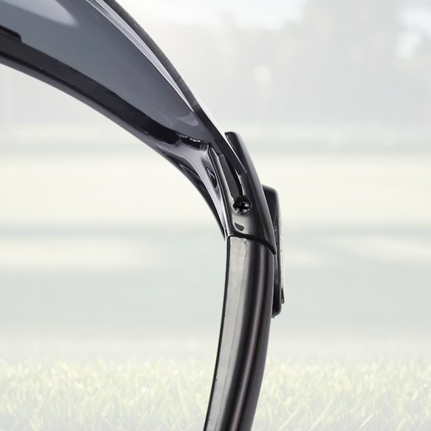 A pair of Sportiq OptiView - Crimson Glow professional sport sunglasses with red reflective lenses and black frame, polarized UV400, polycarbonate frame with TAC lens, displayed on a grass background.