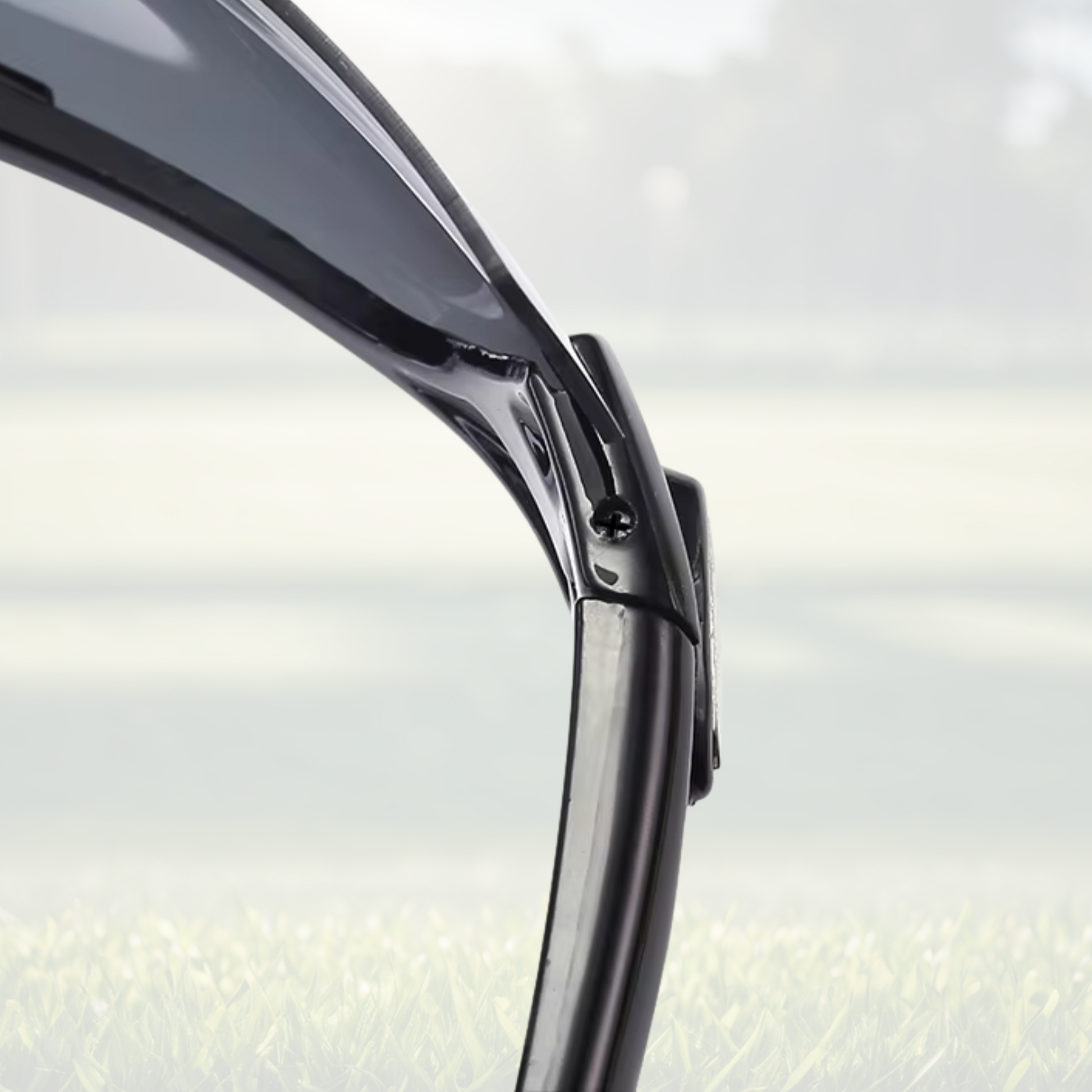 A pair of Sportiq OptiView - Crimson Glow professional sport sunglasses with red reflective lenses and black frame, polarized UV400, polycarbonate frame with TAC lens, displayed on a grass background.