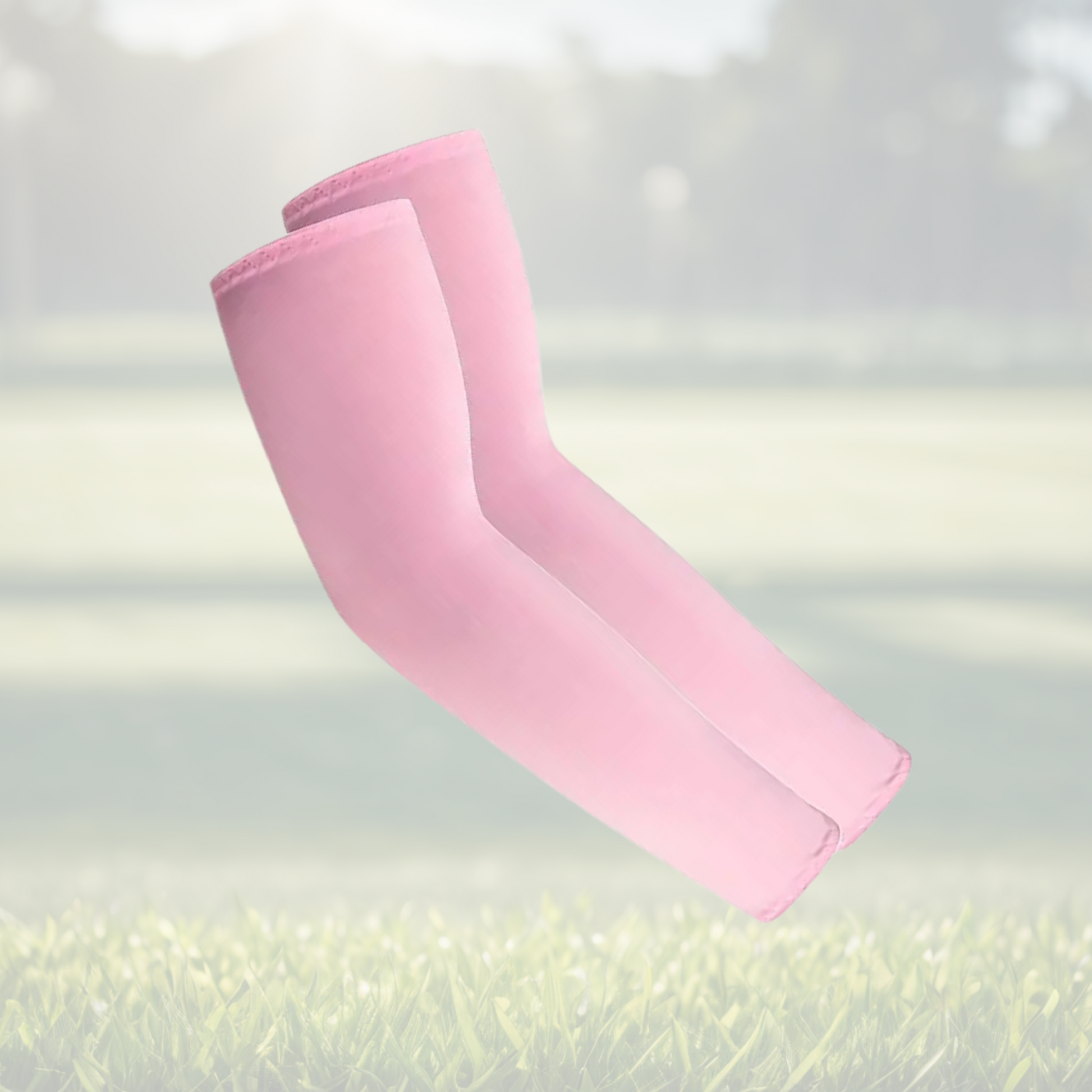 A pair of Sportiq Swift Sleeves in BlushCharge Pink, flexible and stretchy made of breathable polyester with a cooling and sun blocking affect, displayed on a grass background.