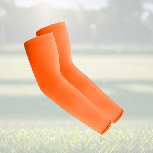 A pair of Sportiq Swift Sleeves in Solar Blaze Orange, flexible and stretchy made of breathable polyester with a cooling and sun blocking affect, displayed on a grass background.