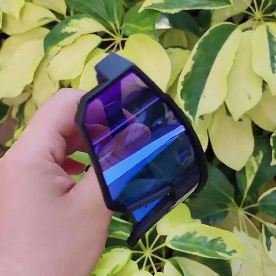 A pair of Sportiq VividShield sunglasses with black and red frame and red reflective lens, polarized UV400, polycarbonate frame with TAC lens, displayed on a grass background.